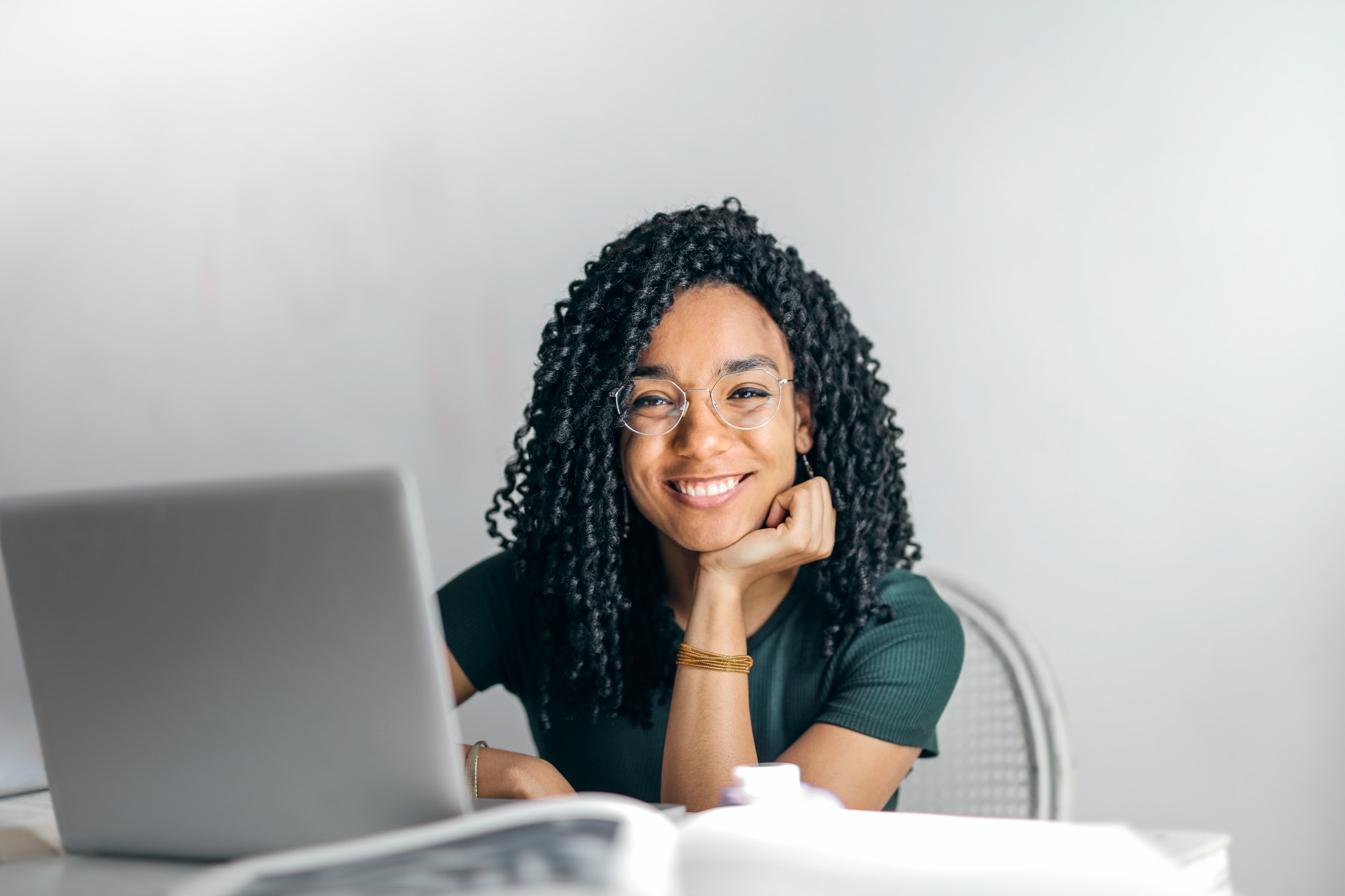 Woman smiling sat with laptop